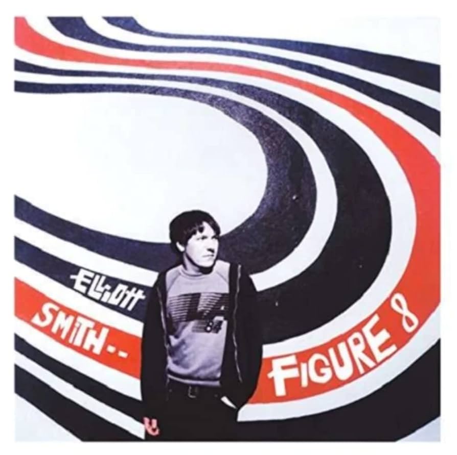 cover de l'album Figure 8 d'Elliot Smith. C'est une photo de l'artiste, appuy&eacute; contre un mur sur lequel plusieurs lignes sont trac&eacute;es, 4 noirs et une rouge. Ces lignes sont arrondies et forment presque un cercle. Le nom d'Elliot Smith et le titre de l'album sont &eacute;crits sur les lignes.