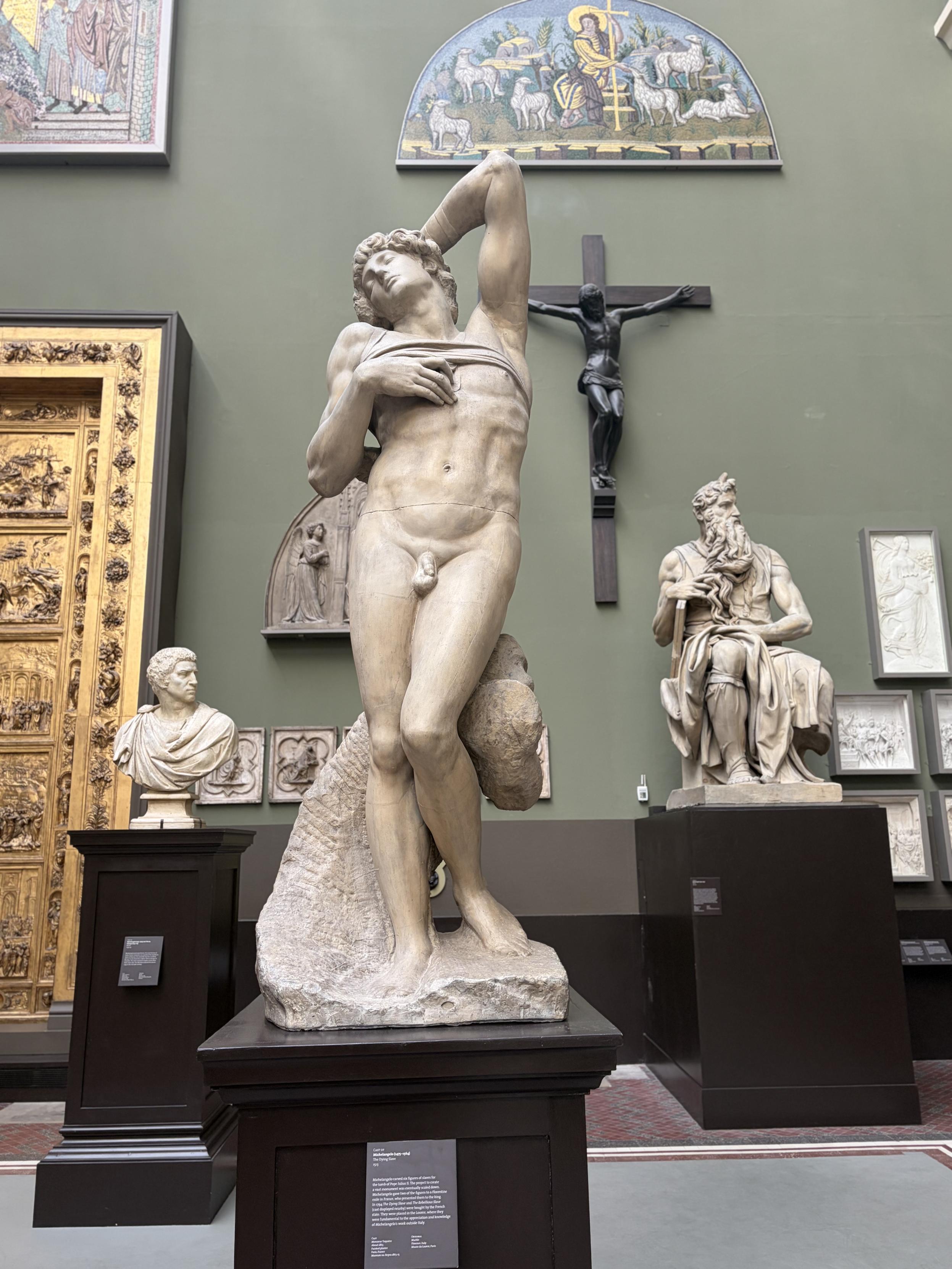 Sculpture d&rsquo;un homme presque nu. Il est debout, avec une jambe l&eacute;g&egrave;rement fl&eacute;chie, une main sur le torse qui retient un morceau de tissu pour exposer son torse, la t&ecirc;te en arri&egrave;re et un bras derri&egrave;re la t&ecirc;te